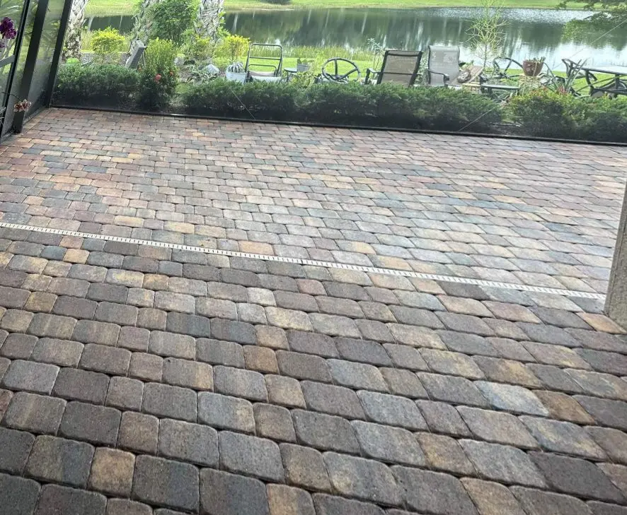 A paver lanai beside a lake in Del Webb, Lakewood Ranch, before