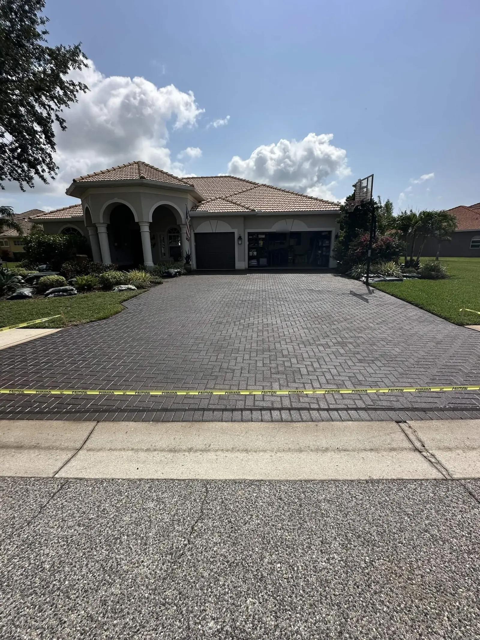 A sealed paver driveway and the house behind it, on a Matt V. Home Solutions job in Southwest Florida