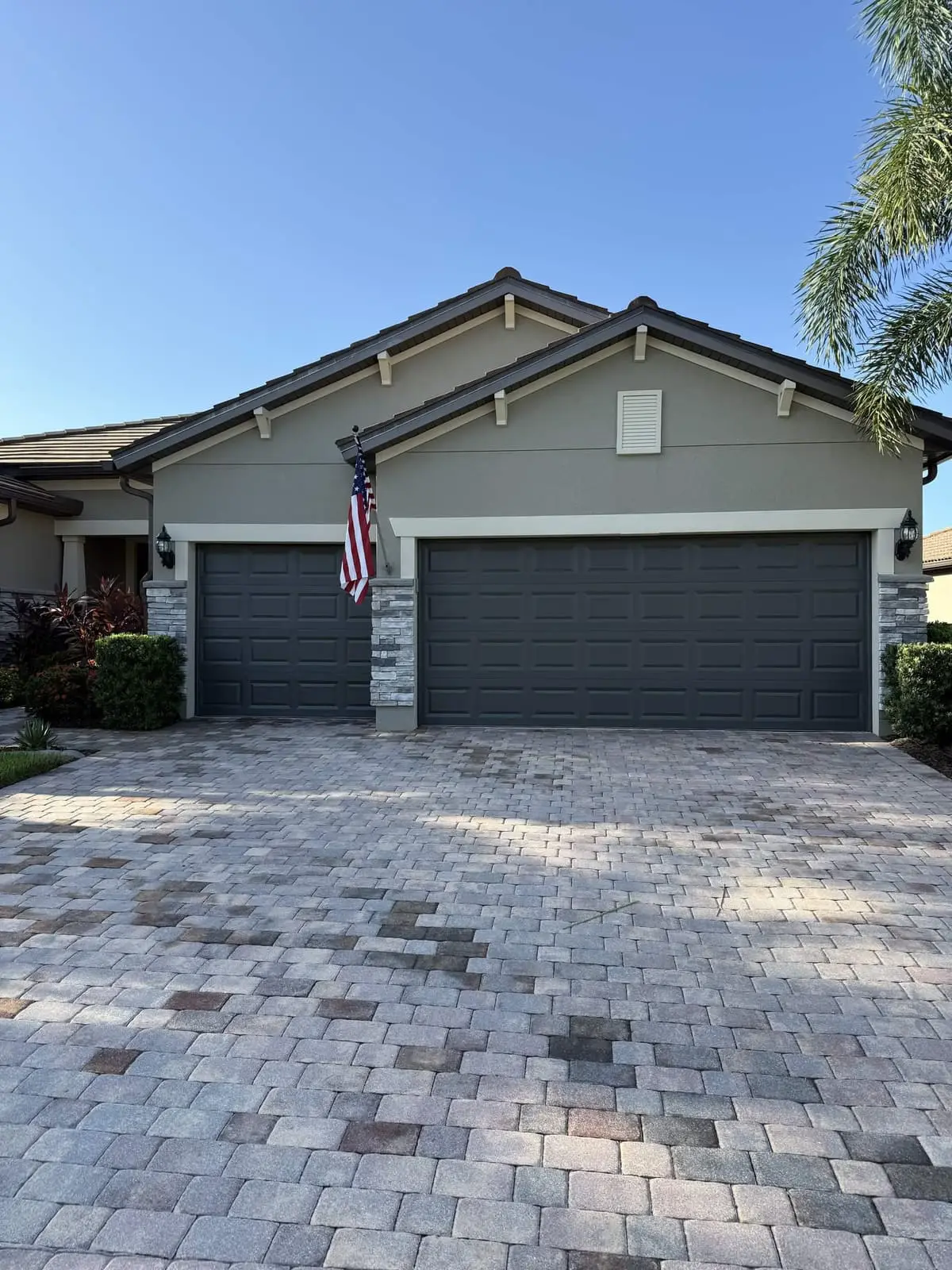 The front of the home with both garage doors painted dark gray