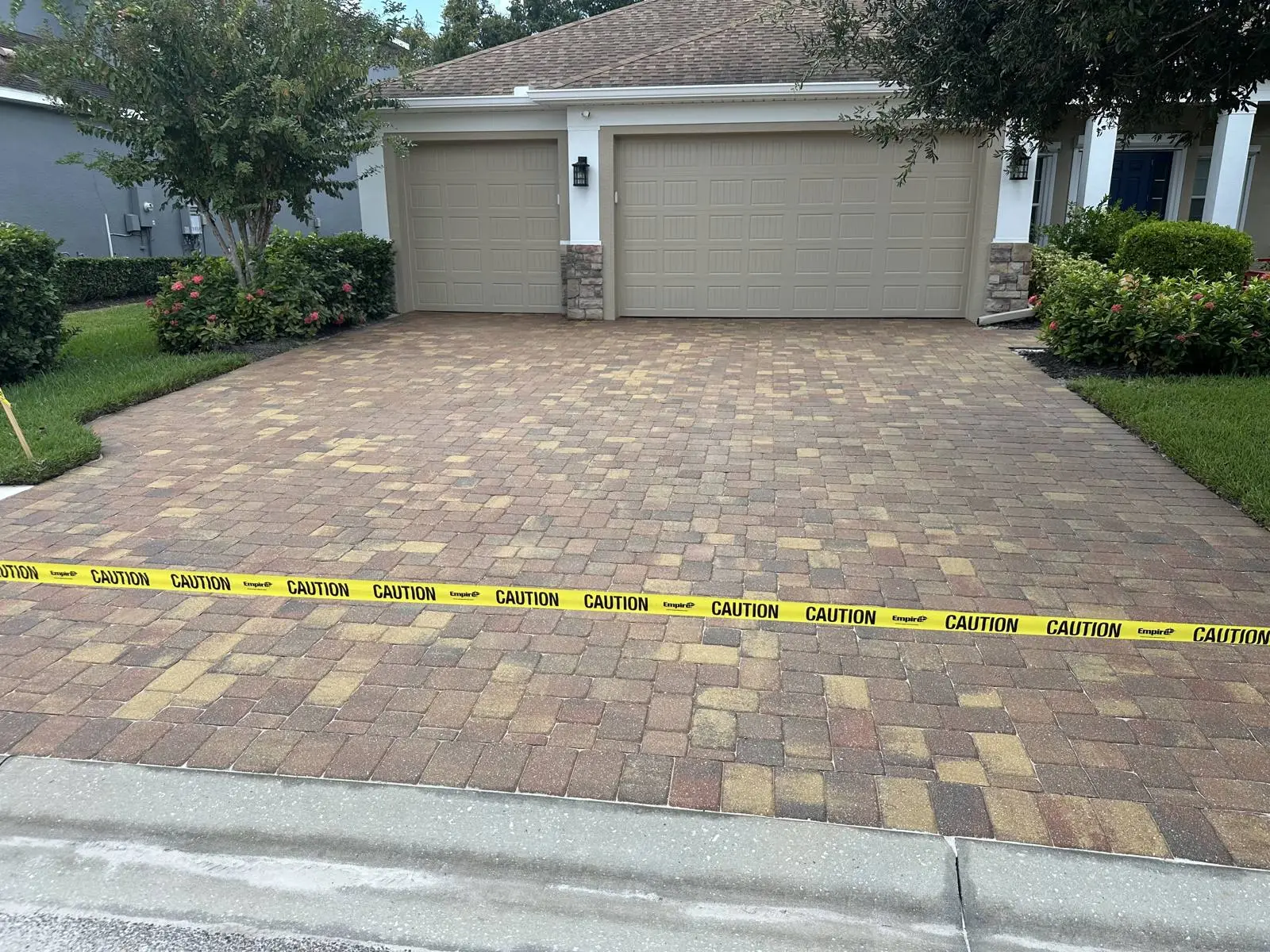 The whole driveway sanded and sealed, taped off while the sealer dries