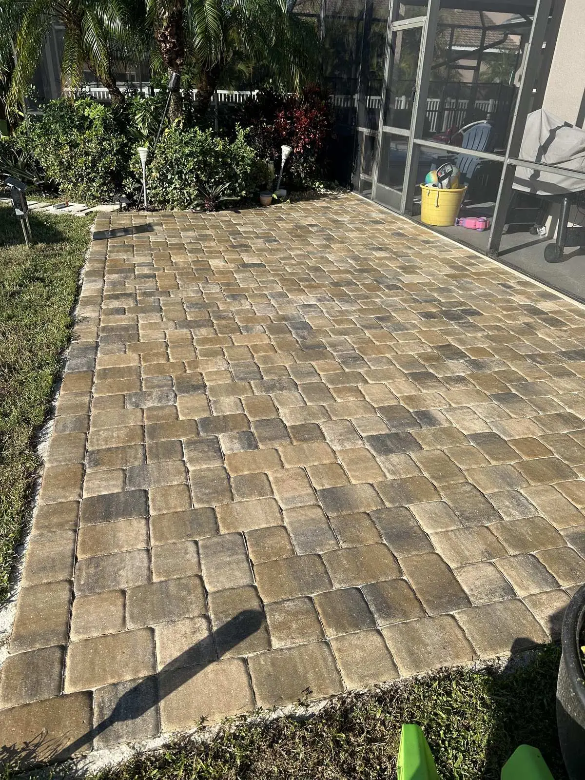 The finished patio, re-sanded and sealed, beside the screen enclosure