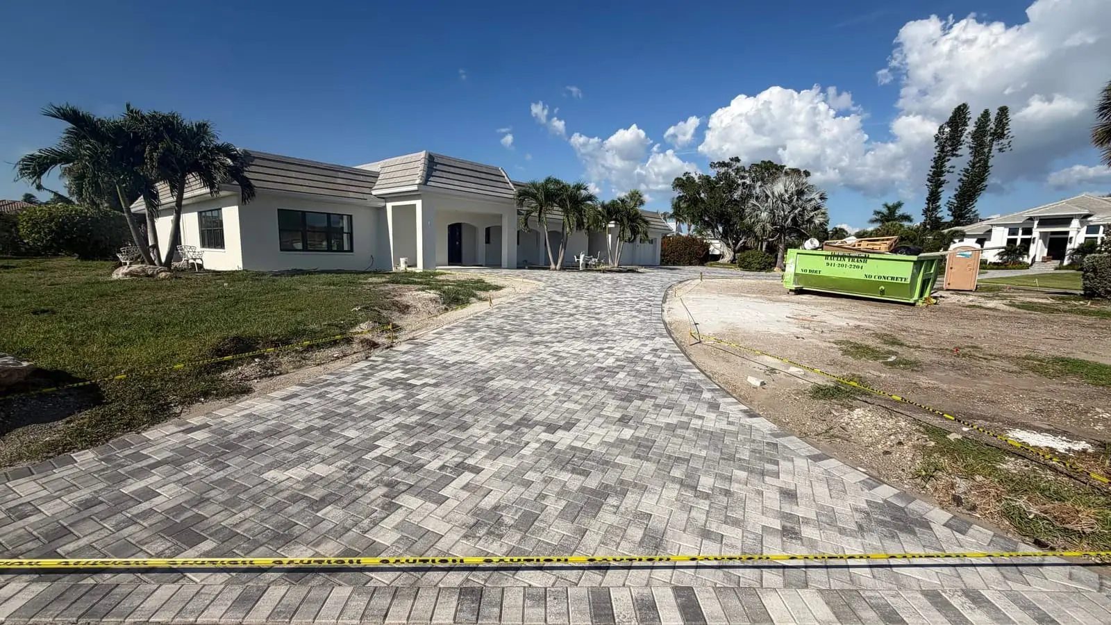 A herringbone paver driveway at a home under construction