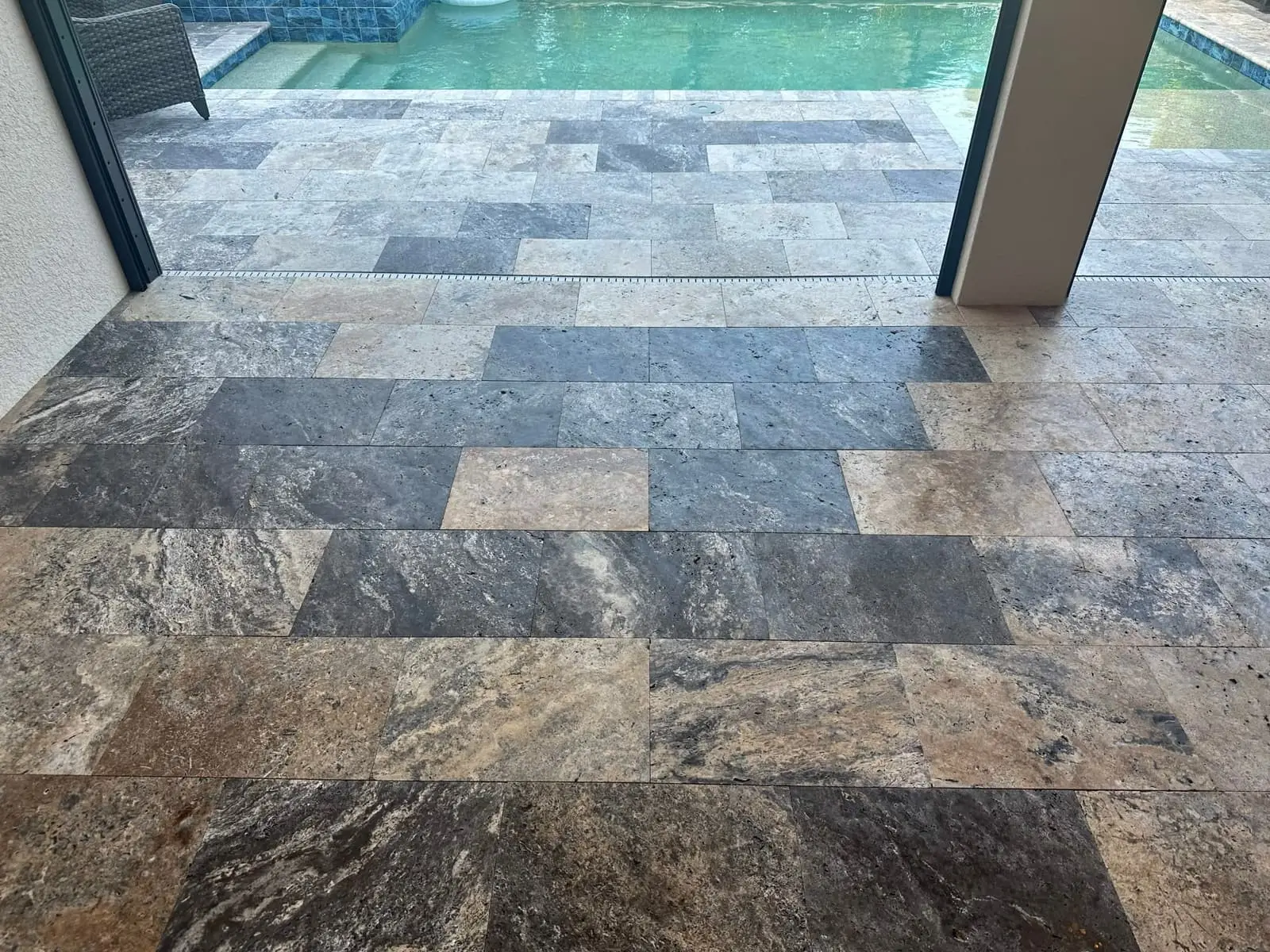 Travertine pavers with a glossy finish beside a pool